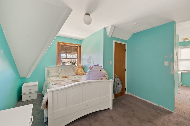 carpeted bedroom featuring multiple windows and lofted ceiling