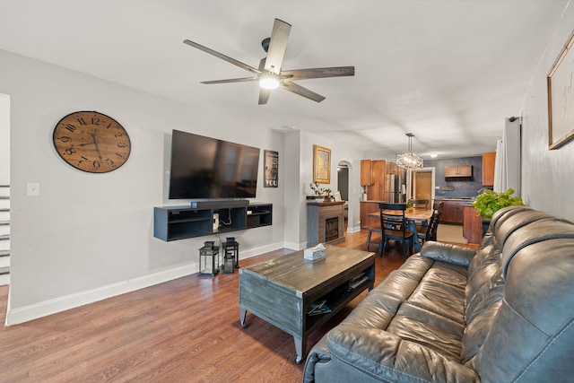 living room with hardwood / wood-style flooring and ceiling fan