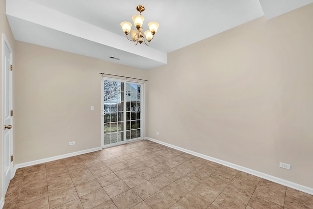 tiled empty room featuring a chandelier