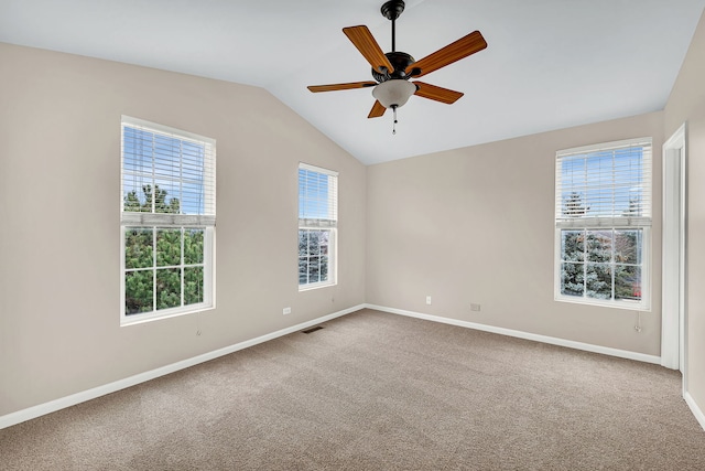 carpeted spare room featuring ceiling fan and vaulted ceiling