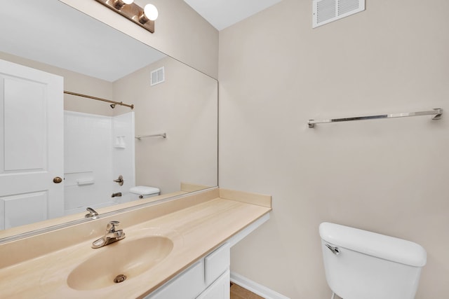 bathroom featuring walk in shower, vanity, and toilet