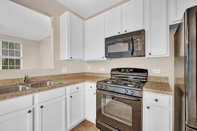 kitchen with light tile patterned floors, sink, white cabinetry, and black appliances