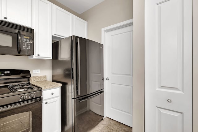 kitchen featuring black appliances, white cabinetry, and light tile patterned floors