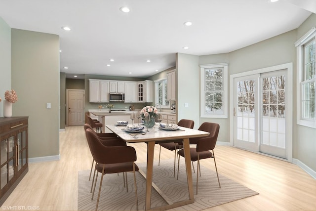 dining area with light hardwood / wood-style flooring