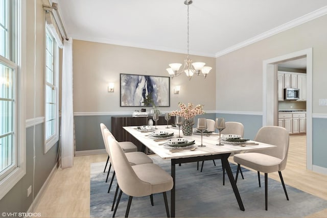 dining space featuring a notable chandelier, light hardwood / wood-style floors, and a wealth of natural light