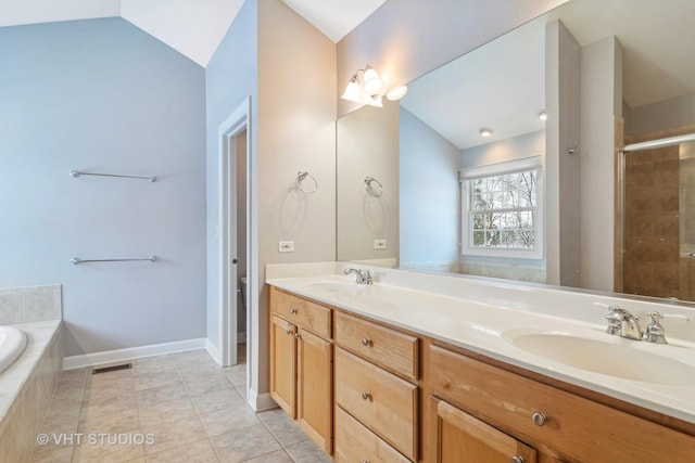 bathroom with tile patterned flooring, vanity, independent shower and bath, and vaulted ceiling