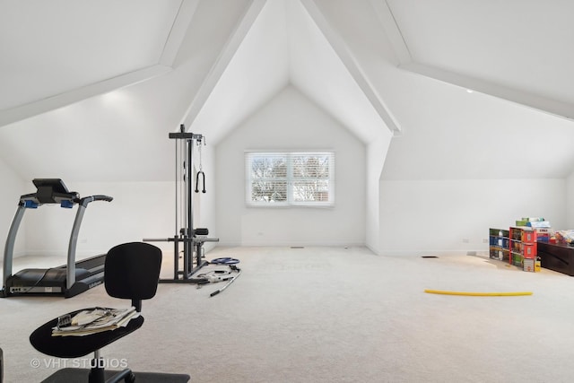 exercise room with carpet floors and vaulted ceiling