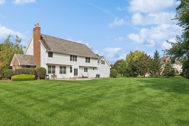 rear view of property with a patio area and a lawn