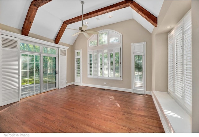 unfurnished living room featuring wood-type flooring, high vaulted ceiling, ceiling fan, and beam ceiling