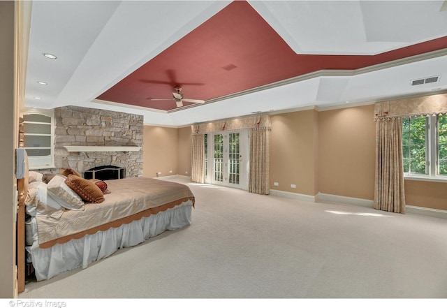 bedroom with a fireplace, a raised ceiling, ceiling fan, and crown molding