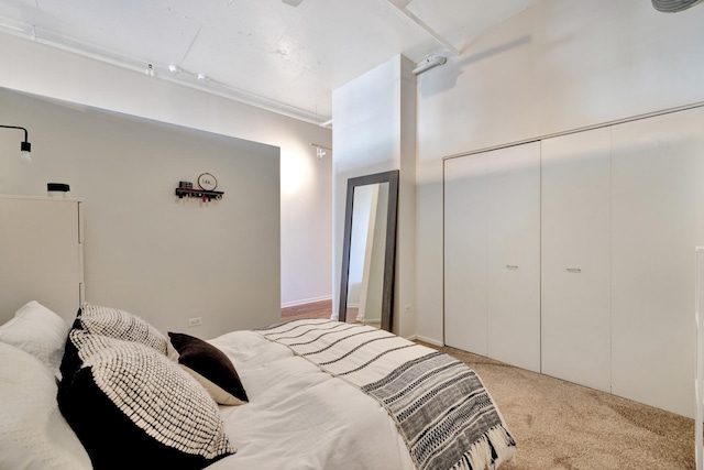 bedroom featuring a closet, light colored carpet, and ornamental molding