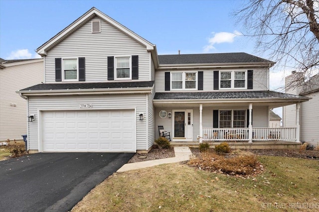 front of property with covered porch, a garage, and a front lawn