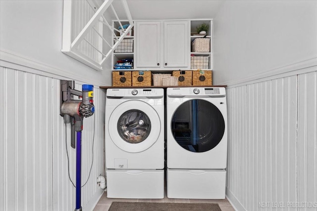 washroom featuring cabinets and independent washer and dryer