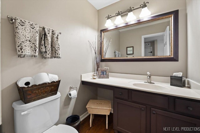 bathroom featuring hardwood / wood-style floors, vanity, and toilet