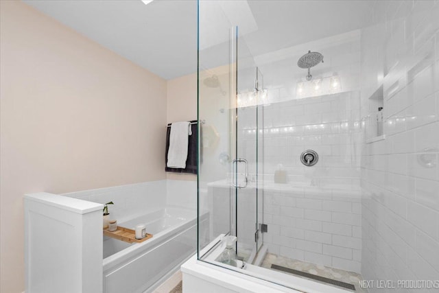 bathroom featuring separate shower and tub