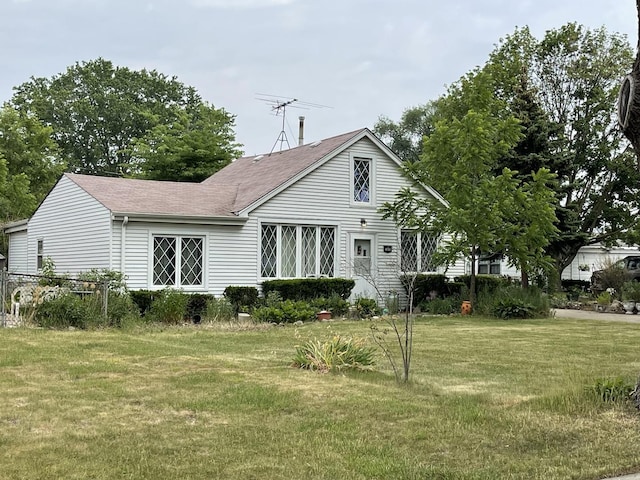 rear view of house with a yard