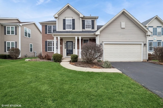 front of property with a garage and a front lawn