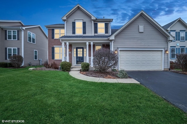 view of property featuring a front yard and a garage