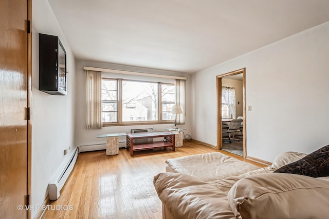 living room featuring hardwood / wood-style floors and a baseboard heating unit