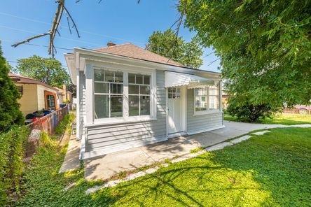 rear view of house featuring a yard