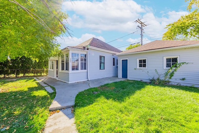 rear view of house with a yard and a patio