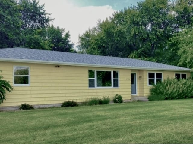 ranch-style house with a front lawn