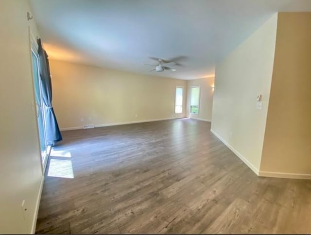 empty room with hardwood / wood-style flooring and ceiling fan