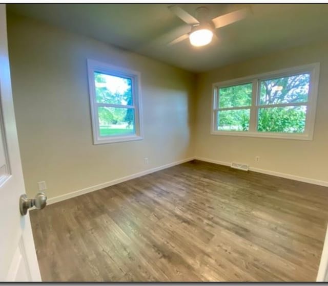 spare room with ceiling fan and hardwood / wood-style flooring