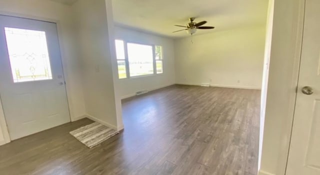 foyer featuring ceiling fan and dark wood-type flooring