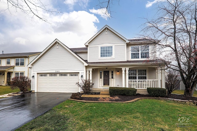 view of front property with a porch, a garage, and a front lawn