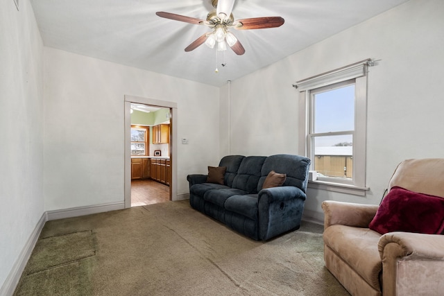 living room featuring light colored carpet and ceiling fan