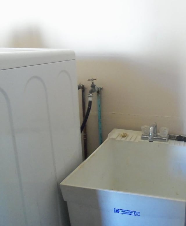 washroom with washer / dryer and sink