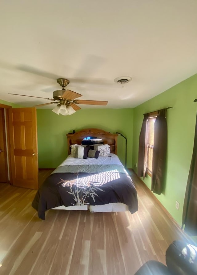 bedroom featuring hardwood / wood-style flooring and ceiling fan