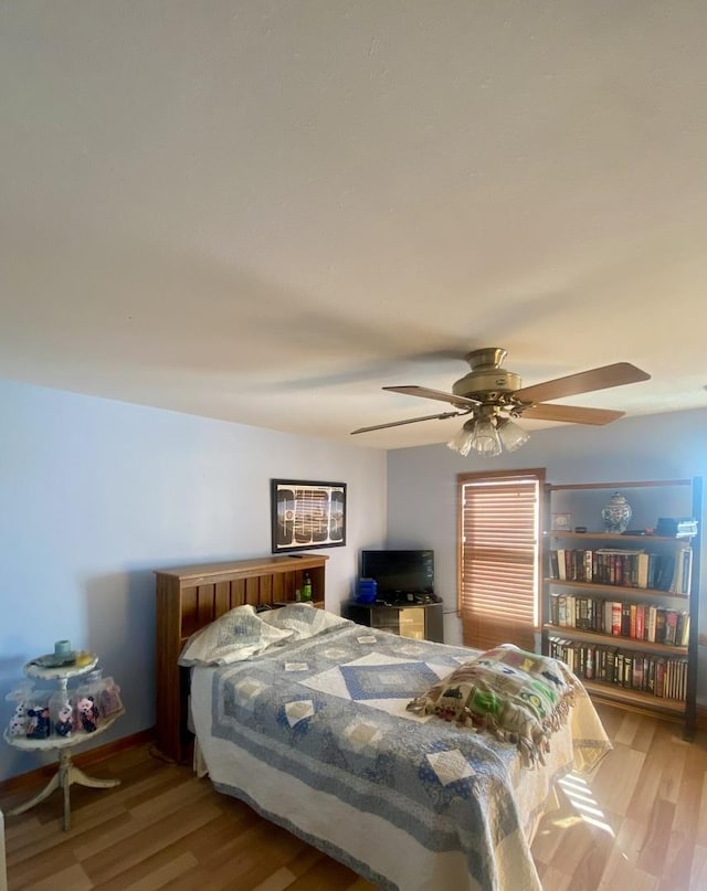 bedroom with hardwood / wood-style flooring and ceiling fan