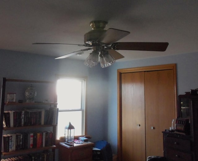 bedroom with ceiling fan and a closet