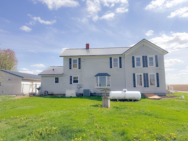 174 Rockyford Rd, Sublette, IL 61367 - back of house with central AC unit, a chimney, and metal roof