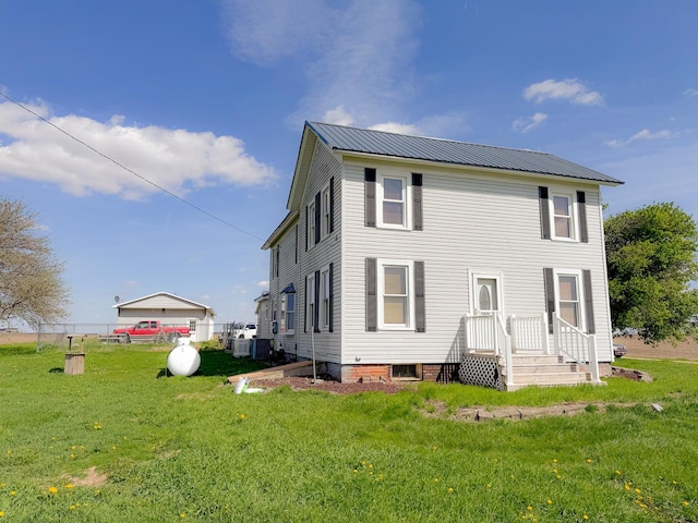 174 Rockyford Rd, Sublette, IL 61367 - rear view of house featuring a yard, metal roof, and central AC unit