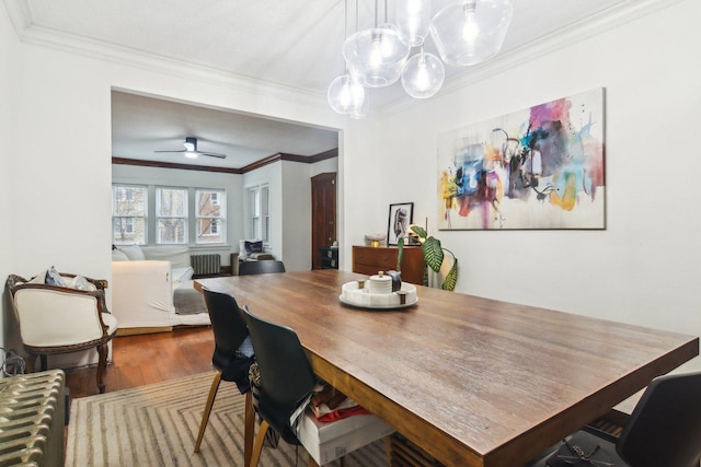 dining area with crown molding, ceiling fan, and hardwood / wood-style flooring