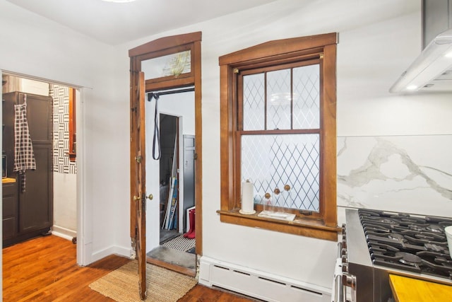 interior space featuring hardwood / wood-style floors and a baseboard heating unit