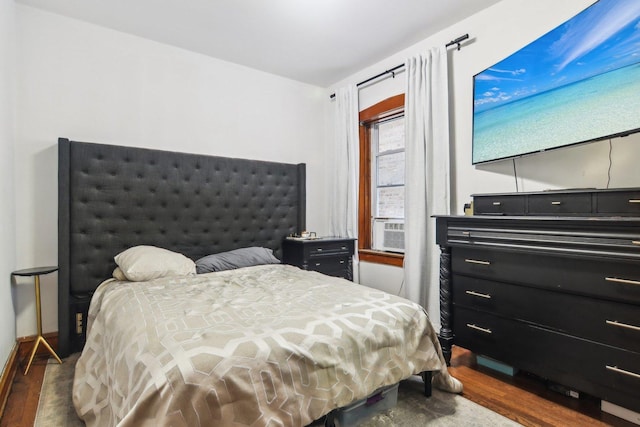 bedroom featuring dark hardwood / wood-style flooring and cooling unit