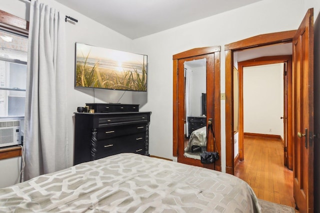 bedroom with wood-type flooring and a closet