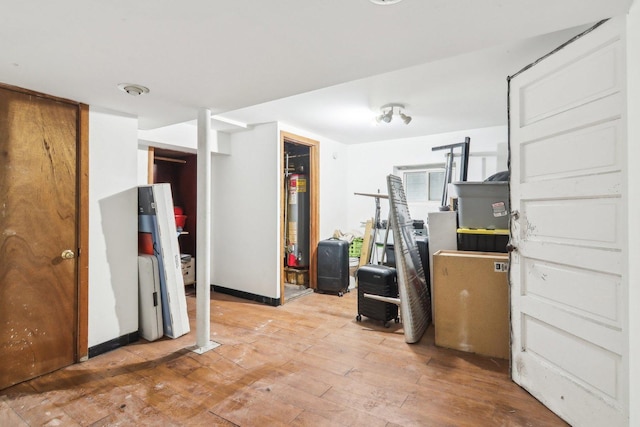 interior space with light hardwood / wood-style flooring and gas water heater