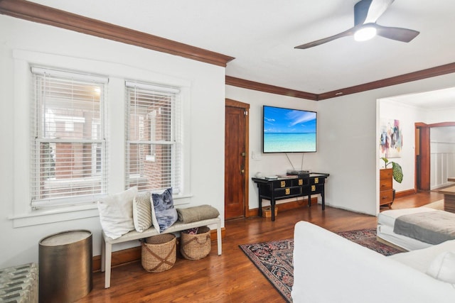 living room with crown molding, dark hardwood / wood-style flooring, ceiling fan, and radiator heating unit