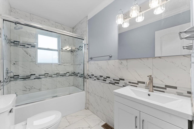 full bathroom with combined bath / shower with glass door, ornamental molding, vanity, tile walls, and toilet