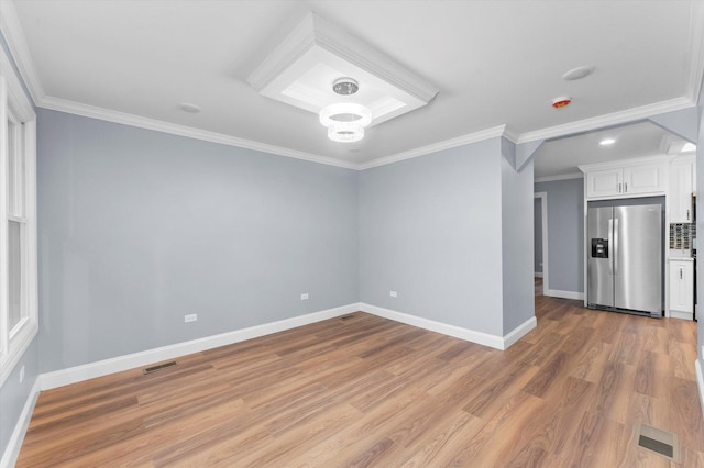 spare room with light hardwood / wood-style flooring and ornamental molding