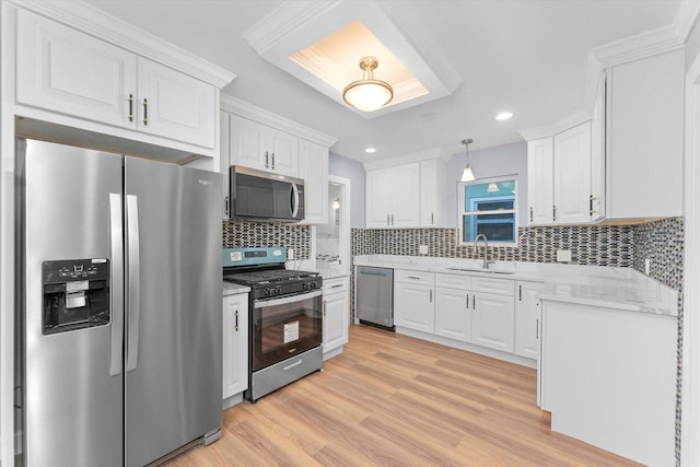 kitchen with decorative backsplash, white cabinetry, sink, and stainless steel appliances