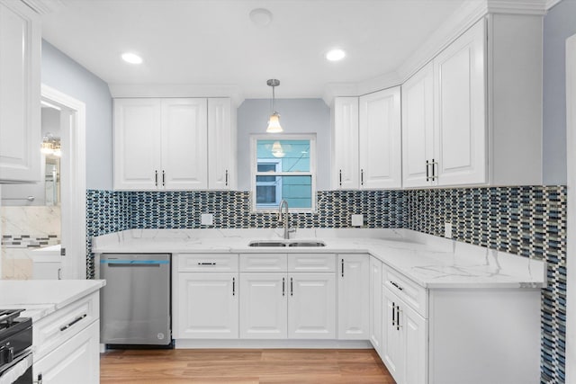 kitchen featuring stainless steel dishwasher, pendant lighting, white cabinetry, and sink