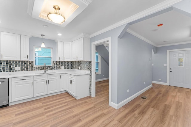 kitchen featuring white cabinets, decorative backsplash, crown molding, and sink