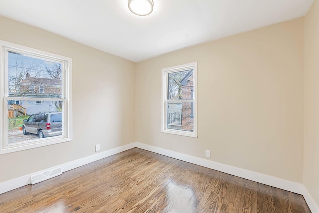 spare room featuring wood-type flooring