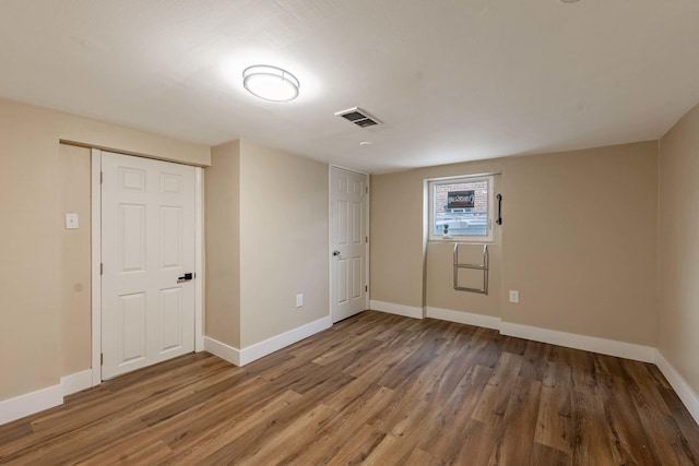 spare room with dark hardwood / wood-style flooring